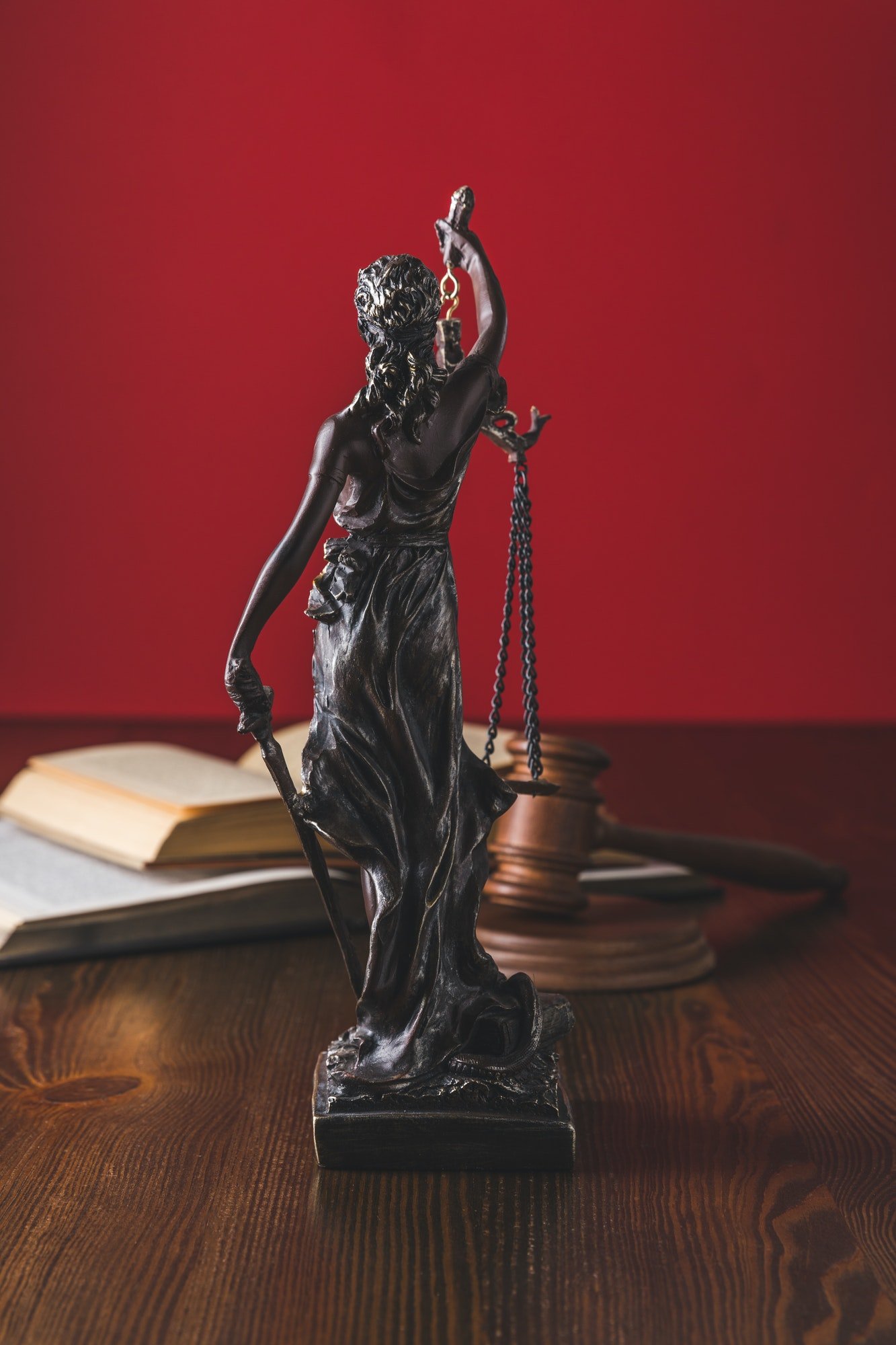 opened-juridical-books-with-lady-justice-statue-on-wooden-table-law-concept.jpg